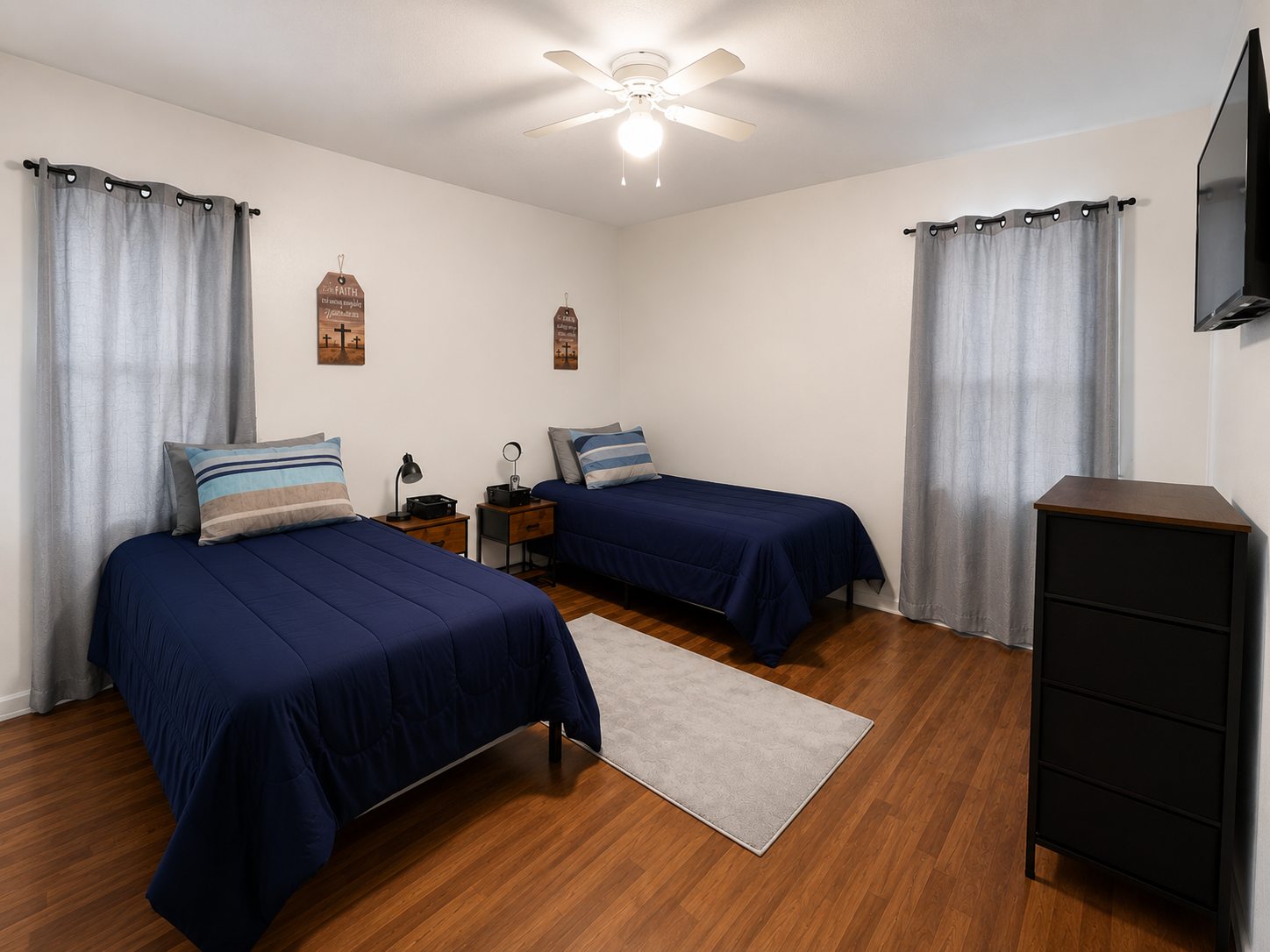 Shared bedroom with two beds, storage, and bedside tables